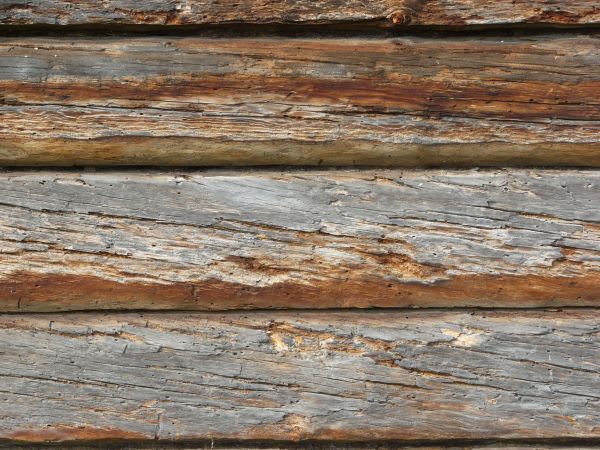 Very old grey planks with fading paint and very rough surfaces.